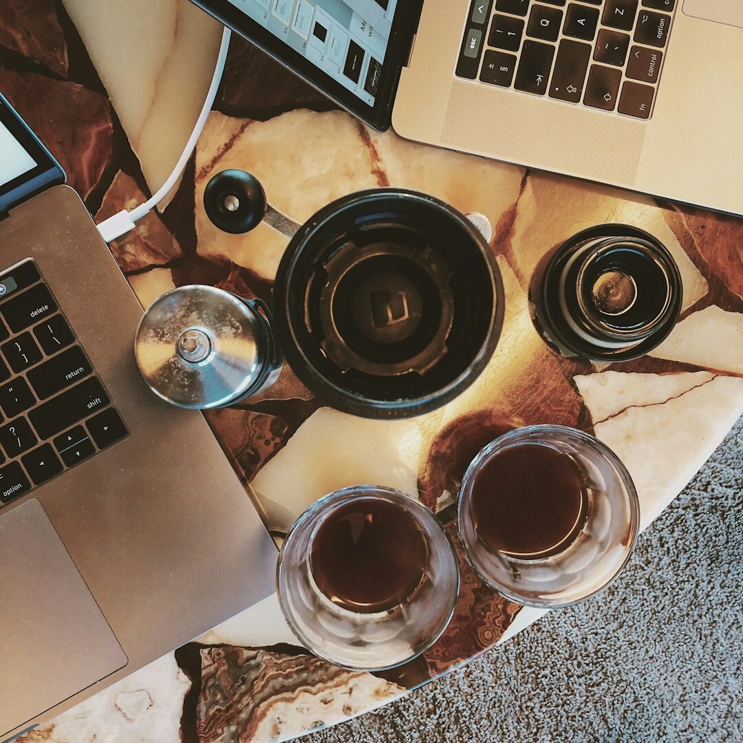 Diverse team working together around a table with laptops